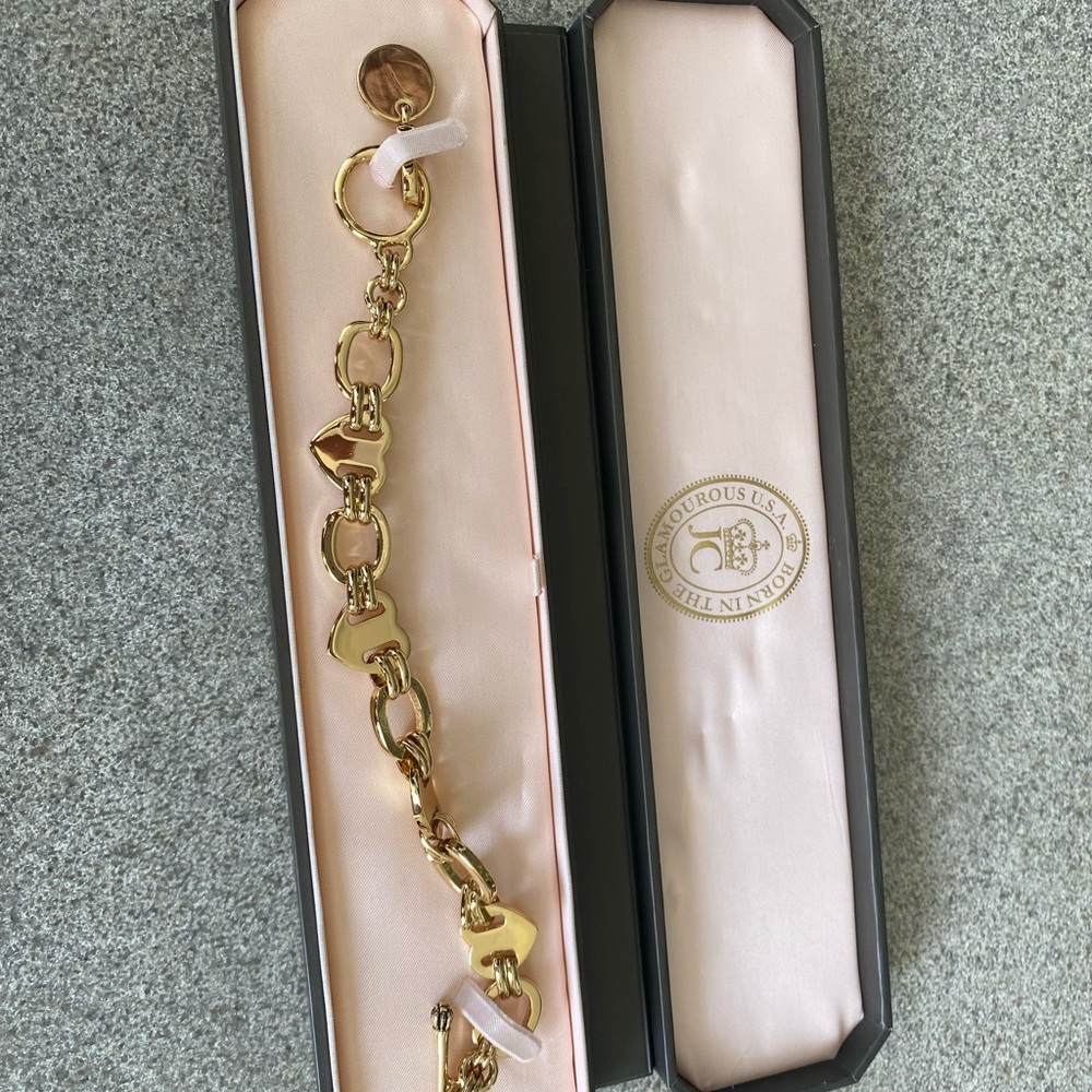 BRAND NEW NEVER BEEN USED Juicy Couture Charm Bracelet. Box included.